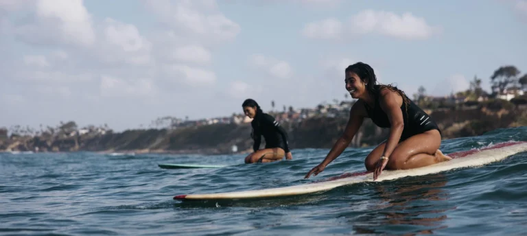 surfers paddling out in finisterre wetsuits 3600x 768x344